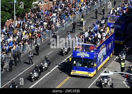 Buses carrying Los Angeles Rams players and coaches drive past fans during  the team's victory parade in Los Angeles, Wednesday, Feb. 16, 2022,  following their win Sunday over the Cincinnati Bengals in