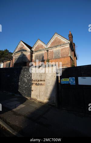 Inhabited large house in Wimbledon being prepared for a building project with hoarding surrounding the exterior, London, England, UK Stock Photo