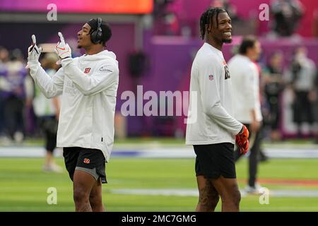 Cincinnati Bengals running back Joe Mixon holds the Lamar Hunt trophy as  Ja'Marr Chase, left and Tee HIggins, center, watch after they beat the  Kansas City Chiefs in the NFL AFC Championship