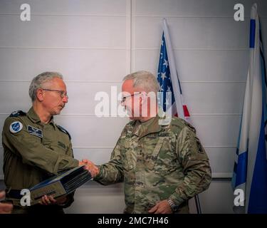 Maj. Gen. Greg Brady, Commanding General of the 10th Army Air and Missile Defense Command, exchanges official gifts with Cmd. Sgt. Maj. Liav Weinbaum, of the Israeli Defense Forces, June 26, 2022 at the Israeli Ministry of Defense. The 10th AAMDC and IDF work together consistently to strengthen the interoperability necessary for maintaining and improving Israel's air and missile defense capacity. Stock Photo