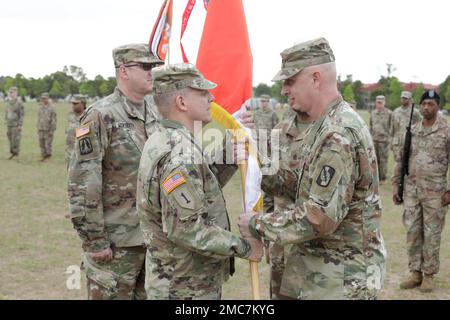 U.S. Army Col. Travis A. Hartman, relinquished commander of the 359th Theater Tactical Signal Brigade (359th TTSB), passes the 359th TTSB guidon to Major. Gen. John H. Phillips,  commanding general, 335th Signal Command Theater, during the change of command ceremony at Barton Field on Fort Gordon in Augusta, Ga on June 26, 2022.  Col. Travis A. Hartman relinquished command of the 359th TTSB to Col. Tracy G. Monteith, ceremony was presided over by Major. Gen. John H. Phillips,  commanding general, 335th Signal Command Theater. Stock Photo