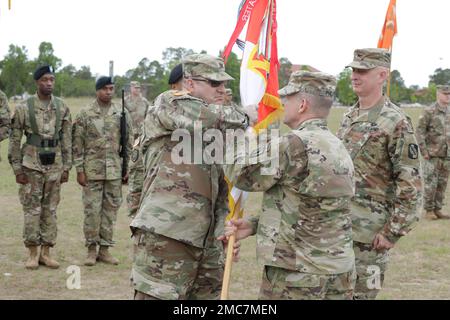 U.S. Army Major. Gen. John H. Phillips,  commanding general, 335th Signal Command Theater, passes the 359 TTSB guidon to Col. Tracy G. Monteith, incoming commander of the 359th Theater Tactical Signal Brigade, during the change of command ceremony at Barton Field on Fort Gordon in Augusta, Ga on June 26, 2022. Col. Travis A. Hartman relinquished command of the 359th TTSB to Col. Tracy G. Monteith, ceremony was presided over by Major. Gen. John H. Phillips,  commanding general, 335th Signal Command Theater. Stock Photo
