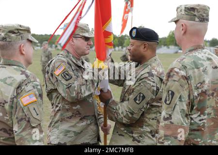 U.S. Army Tracy G. Monteith, in coming commander of the 359th Theater Tactical Signal Brigade, passes the 359th TTSB guidon back to Command Sgt. Maj. Sheldon Gray to complete the passage of command during the change of command ceremony at Barton Field on Fort Gordon in Augusta, Ga on June 26, 2022. Col. Travis A. Hartman relinquished command of the 359th TTSB to Col. Tracy G. Monteith, ceremony was presided over by Major. Gen. John H. Phillips,  commanding general, 335th Signal Command Theater. Stock Photo