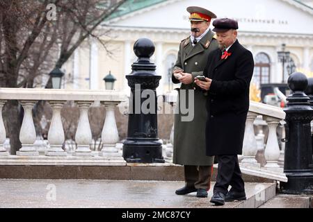 Men in Lenin and Stalin costumes walking on winter street. Red Square, travel in Russia, USSR history Stock Photo