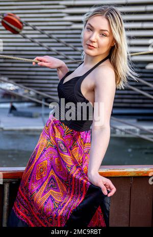 Hayleigh Young, a beautiful and fashionable woman is on board the RRS Discovery ship on an icy cold winters day in Dundee, Scotland Stock Photo