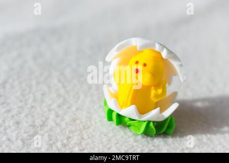 Easter chicken candy on white background. Easter decoration. Springtime holidays. Decorative sweets. Easter chicken in egg. Sugar handmade dessert. Stock Photo