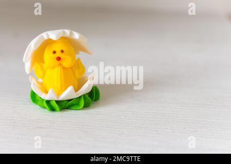 Easter chicken candy on white background. Easter decoration. Springtime holidays. Decorative sweets. Easter chicken in egg. Sugar handmade dessert. Stock Photo