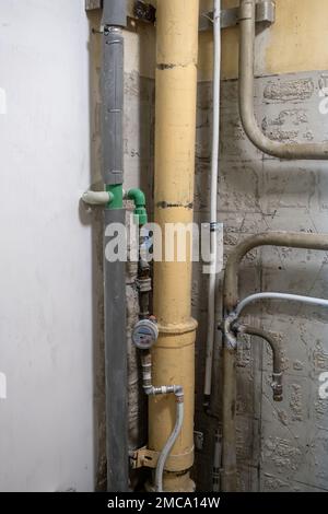 Plumbing system in old premises. Water drainage circuit, Plumbing problems, Works related to leaking faucet, Dark tone, Selective focus. Stock Photo