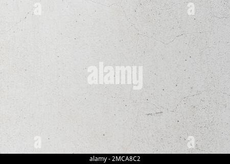 Background of white wall with cracks, texture, wall, concrete, can be used as a background. Fragment of a wall with scratches and cracks Stock Photo