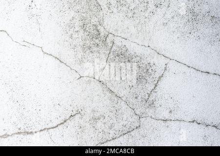 Background of white wall with cracks, texture, wall, concrete, can be used as a background. Fragment of a wall with scratches and cracks Stock Photo