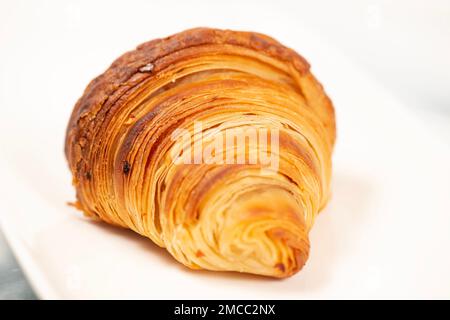 Golden crunchy fresh baked croissant using 75 percent butter weight and the method of 3 single folds. Stock Photo