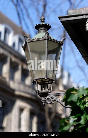 old-fashioned streetlamp in front of blurred background in cologne old town Stock Photo