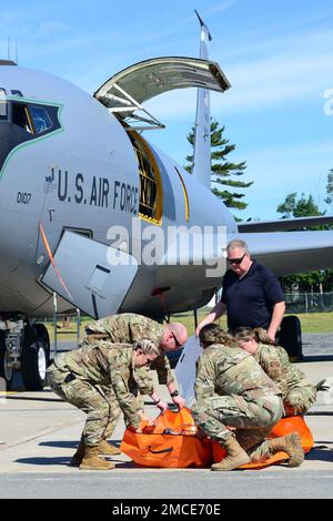 Airmen with the Maine Air National Guard’s 101st Air Refueling Wing’s (101 ARW) Medical Group and soldiers with the Maine Army National Guard’s 126th Aviation Regiment participated in a joint casualty evacuation training exercise, Bangor, ME JUN 29, 2022. During the exercise both airman and soldiers successfully secured and hoisted a simulated casualty multiple times through a side cargo door of a 101 ARW KC-135R before completing a continuous run-through starting with casualty movement from a 126th UH-60 Blackhawk to securing the casualty in a 101 ARW KC-135R aircraft. Stock Photo