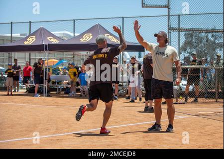 CORONADO, Calif. (June 30, 2022) A West Coast-based Naval Special Warfare Sailor celebrates with former San Diego Padres pitcher Trevor Hoffman, right, after hitting a home run during a softball game at Turner Field on Naval Amphibious Base Coronado. Naval Special Warfare personnel hosted San Diego Padres alumni in a joint softball game in celebration of the 60th anniversary of the U.S. Navy SEAL Teams. Since 1962, Naval Special Warfare has been the nation's highly reliable and lethal maritime special operations force - always ready to conduct full-spectrum operations, unilaterally or with par Stock Photo