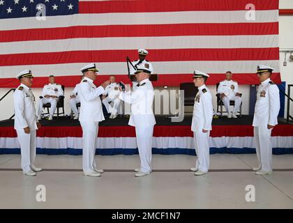 220630-N-OX321-2685 NAVAL AIR STATION SIGONELLA, Italy (June 30, 2022) – Capt. Timothy Thompson, far left, prepares to receive his retirement flag during the passing of the flag and reading of “Olde Glory” during his retirement ceremony held at the conclusion of the Commander, Task Force 67 change of command where he was relieved by Capt. Bryan Hagar as the Commodore for CTF 67. Thompson retires after having served 37 years in the United States Navy. Stock Photo