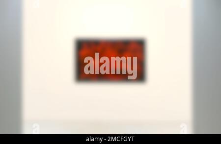 Blurred image of red and black artwork on the wall in art gallery. Stock Photo