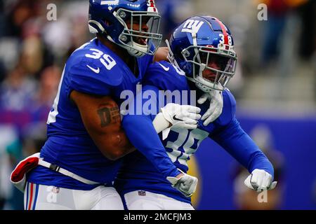 New York Giants fullback Elijhaa Penny (39) and defensive back Steven  Parker (38) react after a defensive play against the Washington Football  Team during the first quarter of an NFL football game, Sunday, Jan. 9,  2022, in East Rutherford, N.J. (AP Pho