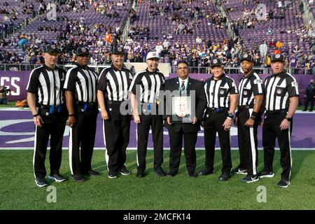 Officials, from left to right, replay official Kevin Brown, down judge  Michael Dolce, field judge Jimmy Buchanan, umpire Bryan Neale, referee  Shawn Smith, back judge Dino Paganelli, line judge Mark Steinkerchner and