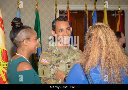 FORT MEADE, Md - Lt. Col. Chaveso Cook, the incoming commander of the Headquarters Command Battalion, United States Army Garrison Meade, speaks with family and friends after a formal change of command ceremony here, June 30. Cook initially graduated from the United States Military Academy in 2004 as an air defense artillery officer before branching to psychological operations. Stock Photo