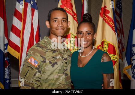 FORT MEADE, Md - Lt. Col. Chaveso Cook, the incoming commander of the Headquarters Command Battalion, United States Army Garrison Meade, poses with his wife after a formal change of command ceremony here, June 30. During the ceremony, Cook accepted the rights and responsibilities inherent to the position of commander. Stock Photo