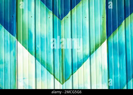 Colorful Amish star quilt patterns painted on aluminum siding in cool color tones. Stock Photo