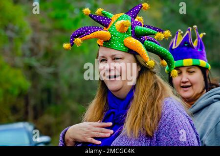 A woman in a Mardi Gras costume watches the Krewe de la Dauphine Mardi Gras parade, Jan. 21, 2023, in Dauphin Island, Alabama. Stock Photo