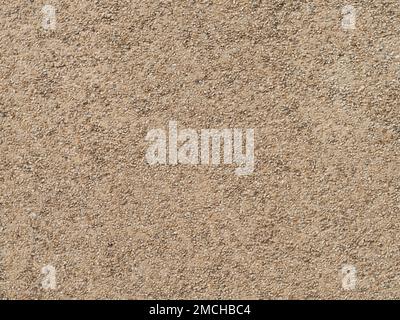 Exposed aggregate concrete wall texture. Empty background pattern of a building facade in East Germany. Architectural design with small stones. Stock Photo