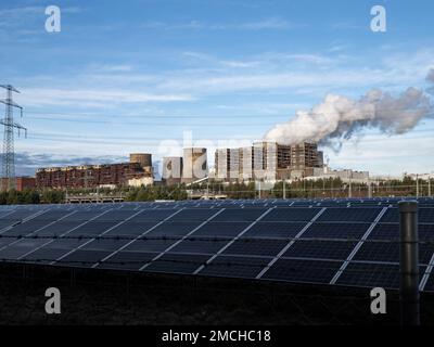 Solar plant versus an old lignite fired power station. Renewable energies mixed with conventional technology are the status quo. Carbon dioxide Stock Photo