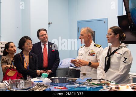 VUNG RO BAY, Vietnam (July 3rd, 2022) – Capt. Timothy Quast, Military Sealift Command hospital ship USNS Mercy (T-AH 19) commanding officer, middle left, briefs Mr. Marc Knapper, U.S. Ambassador to Vietnam, and members of the Phu Yen Provincial People’s Committee on the ship's surgical capabilities in support of the Pacific Partnership 2022 Vietnam closing ceremony. Now in its 17th year, Pacific Partnership is the largest annual multinational humanitarian assistance and disaster relief preparedness mission conducted in the Indo-Pacific. Stock Photo