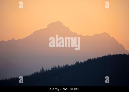Orange sunset sky over the Rocky Mountains, Jasper National Park, Alberta, Canada Stock Photo