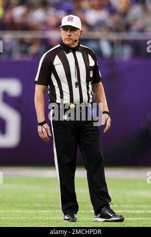 Referee John Hussey (35) reviews a play using instant replay during the  first half an NFL footb …