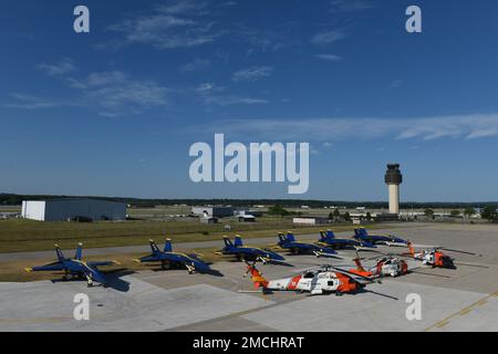 Three MH-60 Jayhawk helicopters positioned in front of six F/A-18 Blue Angels Super Hornets outside of the hangar at Air Station Traverse City, Michigan, July 3, 2022. Coast Guard Air Station Traverse City and the U.S. Navy Blue Angels performed in an airshow during National Cherry Festival. Stock Photo