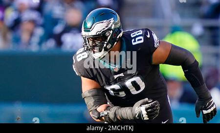 Philadelphia Eagles offensive tackle Jordan Mailata (68) talks with punter  Brett Kern (13) near the bench during the second half of an NFL divisional  round playoff football game against the New York