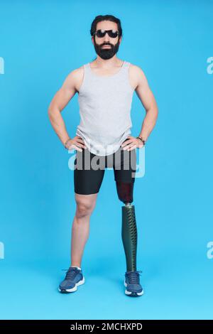 Man with sunglasses standing with a prosthetic leg Stock Photo