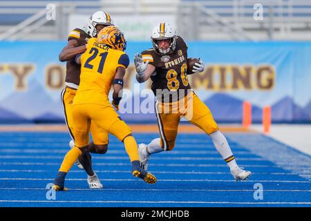 Wyoming tight end Parker Christensen 80 looks to stiff arm Kent