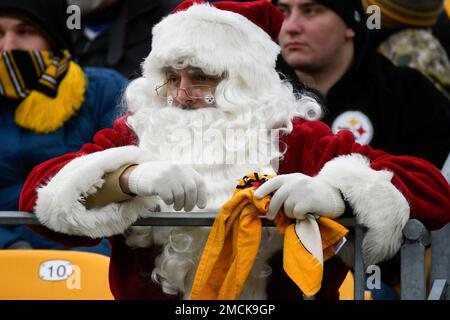 A Tennessee Titans fan is dressed as Santa as he watches the