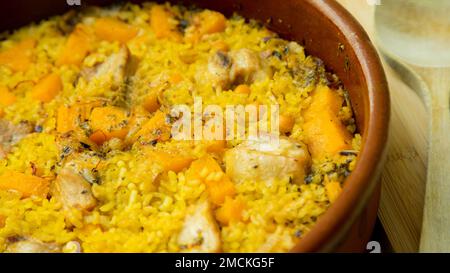 Original spanish paella recipe with meat cooked in a casserole in the oven. Stock Photo