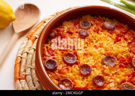 Original spanish paella recipe with meat cooked in a casserole in the oven. Stock Photo