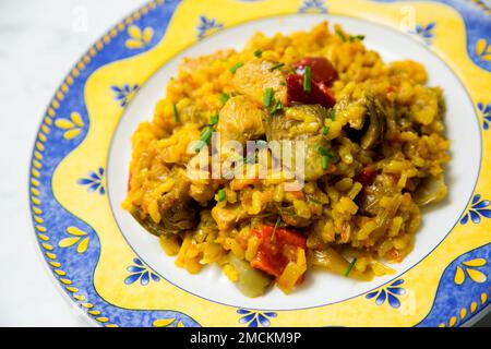 Original spanish paella recipe with chicken and vegetables. Stock Photo