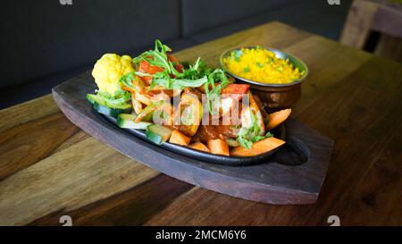 Roasted vegetables with curry rice. Traditional Indian Food. Stock Photo