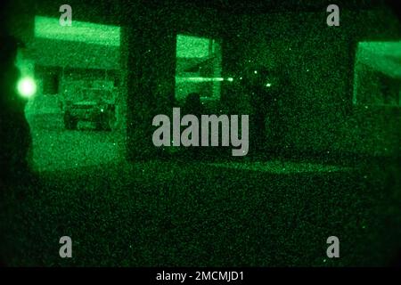 A Green Beret with 2nd Battalion, 10th Special Forces Group (Airborne), scans an avenue of approach for enemies during a nighttime raid on Fort Carson, Colorado, July 6, 2022. The 10th SFG(A) Special Forces Operational Detachment Alpha conducted training missions to rehearse TTPs (Tactics, Techniques, and Procedures) and standard operating procedures to enhance lethality. Stock Photo