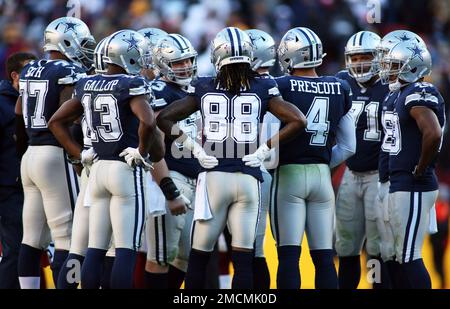 Dallas Cowboys players huddle up during an NFL football game