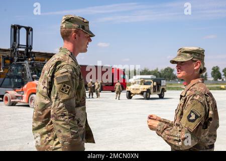 U.S. Army Capt. Kelsey Haslam, commander assigned to Headquarters and Headquarters Company, 526th Brigade Support Battalion, acts as the officer in charge (OIC) during an equipment download at Mihail Kogălniceanu Air Base, Romania, July 7, 2022. 101st units will support V Corps' mission to reinforce NATO's eastern flank and engage in multinational exercises with partners across the European continent to reassure our Nation's Allies and deter further Russian aggression. Stock Photo