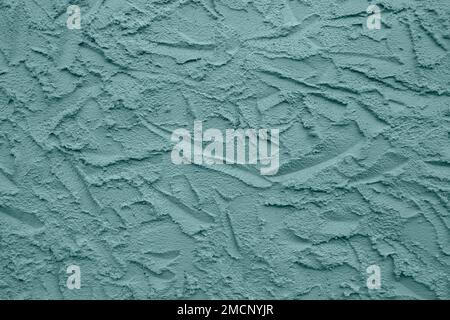Abstract drawing on plastered wall. Toned in color Tidewater Green, background, texture. Copy space. Selective focus. Stock Photo