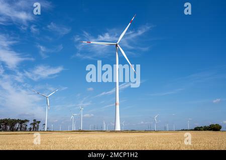 Wind turbines in a crop field on a beautiful sunny day in Germany Stock Photo