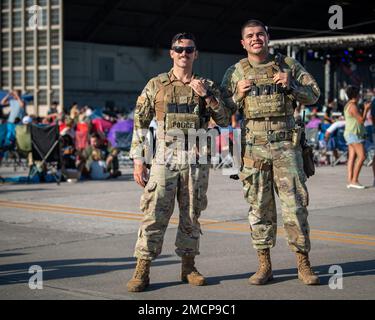 U.S. Air Force Senior Airman Gabriel Alequin-Gonzalez (left) and Airman 1st Class Tristen Cardoza, defenders assigned to the 6th Security Forces Squadron, patrol the flightline at MacDill Air Force Base, Florida during a concert featuring Gary Sinise and the Lt. Dan Band, July 8, 2022. The exclusive concert featured food trucks, games, and a meet and greet with the band to honor MacDill personnel and their families. The band’s mission is to uplift and celebrate defenders and their families on military bases at home and abroad. Stock Photo