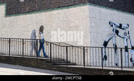 A graffiti mural of acrobats on a white wall at Strathclyde University in North Portland Street; part of Glasgow's City Centre Mural Trail. Stock Photo