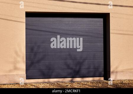 Modern garage door. Large automatic up and over door. Close- up photo, natural light. Stock Photo