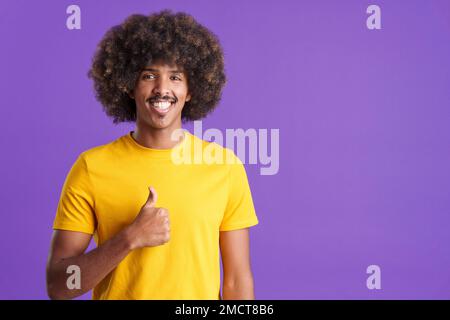 Happy african man gesturing agreement raising a thumb up Stock Photo