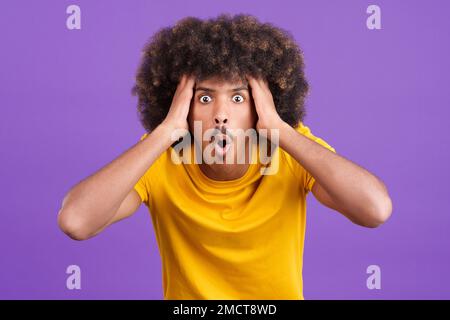 Surprised african man looking at the camera gesturing Stock Photo